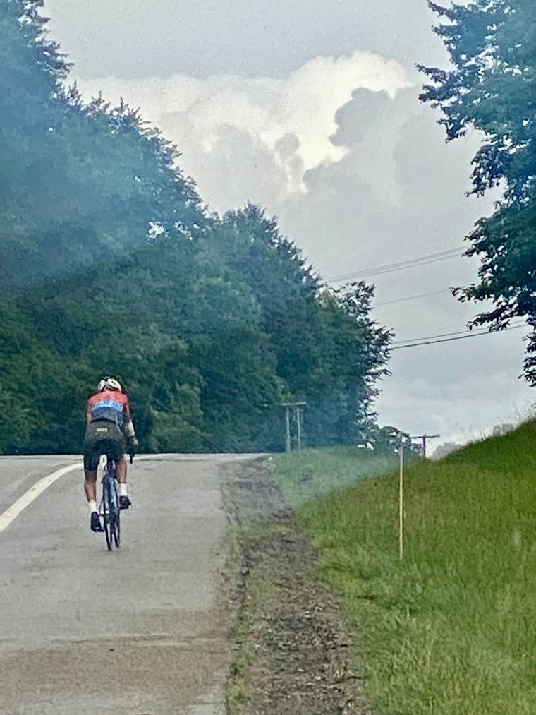 A cyclist on an open country road